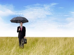 Man In Field With Umbrella