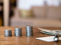 someone struggling to make ends meet counting their change